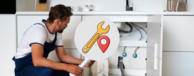 Local plumber repairing under a kitchen sink.